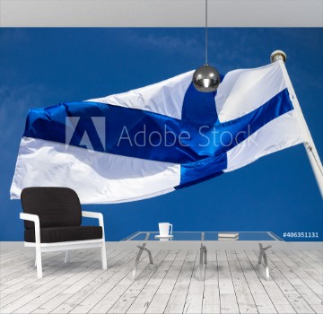 Picture of Finnish national flag on the wind against the blue sky